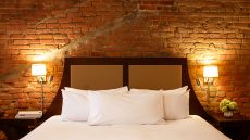 Bed and headboard at Hotel Nelligan