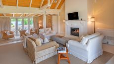 Cottage lounge angle view fire place at Wharekauhau