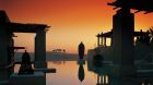 pool with camels sunset