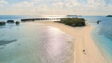Aerial Sandbank Couple walking sunrise COMO Cocoa Island