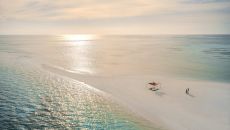 Aerial Sandbank Couple walk COMO Cocoa Island