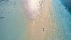 Aerial Sandbank Couple Walking COMO Cocoa Island