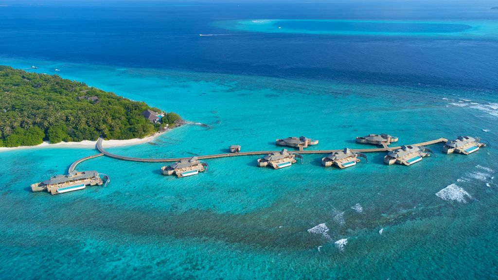 Soneva Fushi water retreats and overwater villas surrounded by turquoise lagoon in the Baa Atoll Maldives