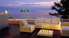 See more information about Amphitryon Hotel veranda restaurant sunset