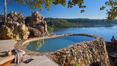 See more information about Singita Pamushana Lodge pool overlooking lake