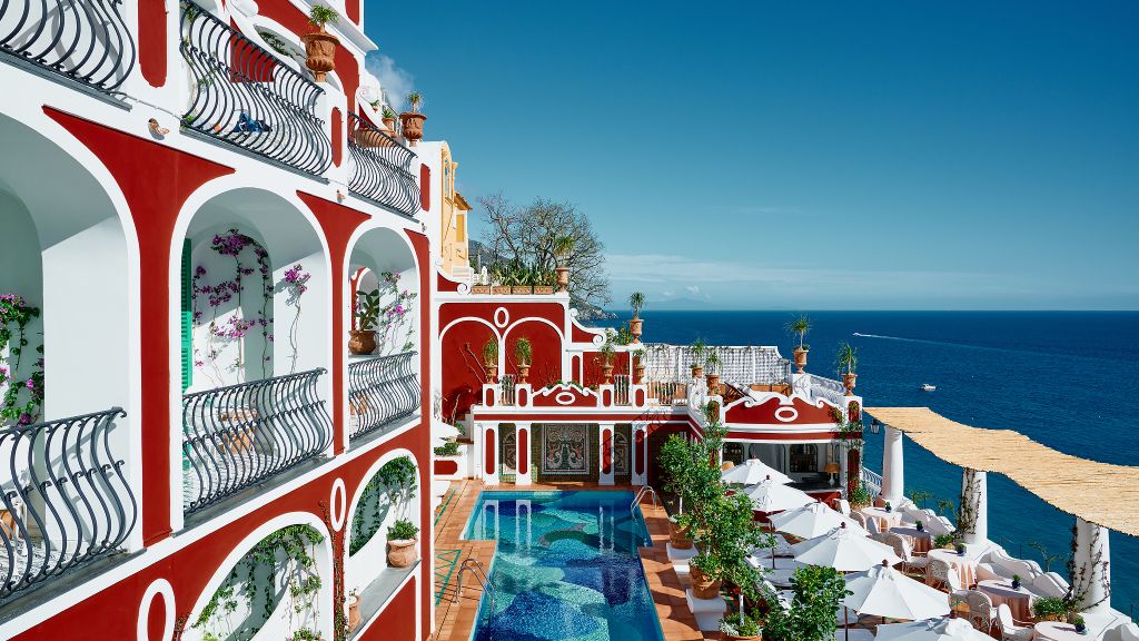 Le Sirenuse luxury hotel in Positano with iconic red facade, terraces overlooking the Mediterranean Sea on the Amalfi Coast Italy