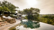 Outdoor pool with view of trees