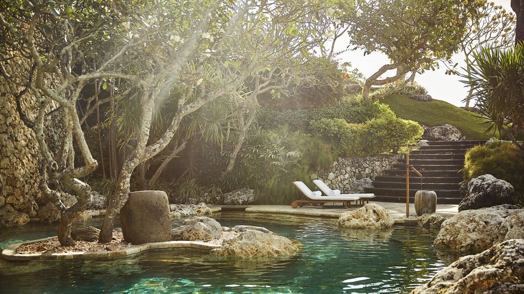 Four Seasons Resort Bali Jimbaran Bay Balinese-style villas cascading down a hillside toward the beach Indonesia