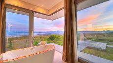 romantic spa bath covered in rose petals at the villa