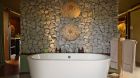 Bathtub with stone wall