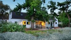 Garden cottage with glass kitchen at sundown at Babylonstoren