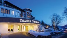 winter exterior night front entrance at Hotel Traube Tonbach