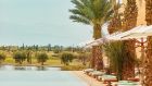 main pool atlas golf view sky horizon lounge chair parasol palm vegetation sun day at Park Hyatt Marrakech