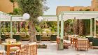 restaurant pavillon terrace pool pergolas tables vegetation resort view at Park Hyatt Marrakech