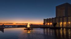 night pool view with flame Banyan Tree Tamouda Bay