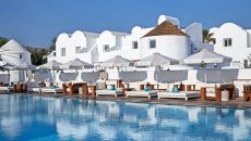 See more information about Nikki Beach Resort & Spa Santorini pool with buildings at Nikki Beach Resort and Spa Santorini