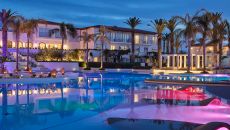 swimming pool with palm tree at caramel resort at Caramel A Grecotel Resort to Live